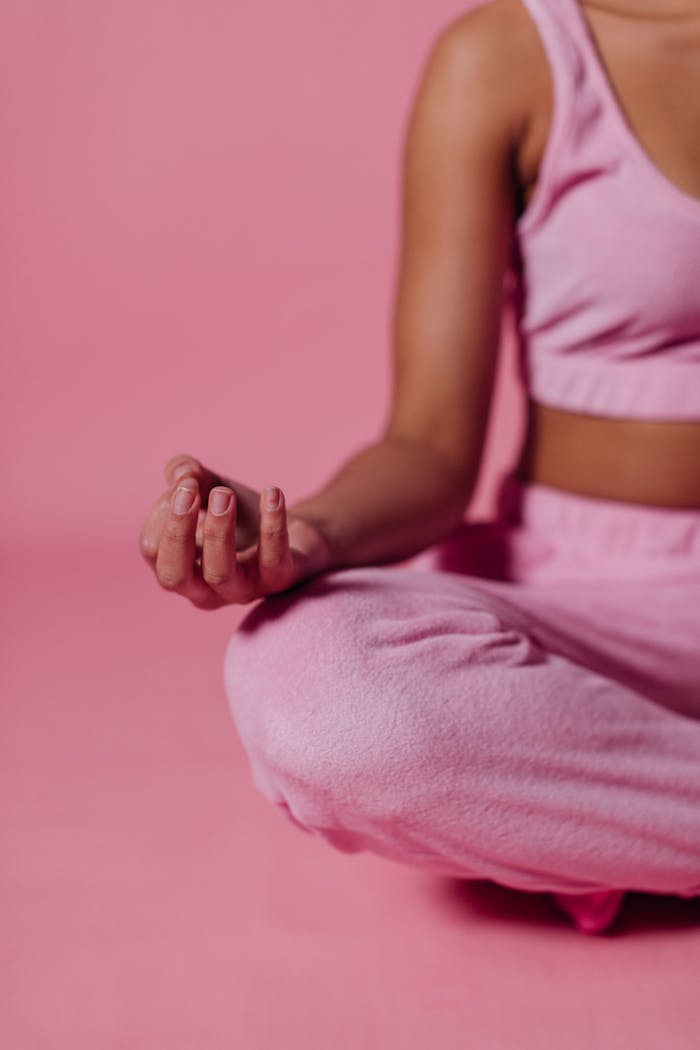 Close-Up Photo of Woman in Pink Crop Top Meditating